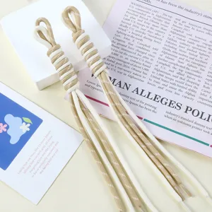 Detailed view of dual-color hand-woven nylon cords with tassels for DIY bag charms