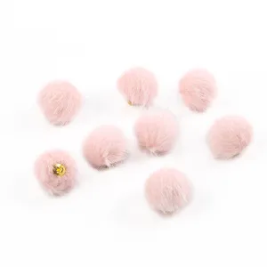 Dettaglio macro di pompon in ecopelliccia rosa da 17mm per la creazione di gioielli DIY.