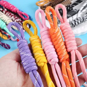 Multi-colored braided nylon rope charms for phones and bags shown in hand.