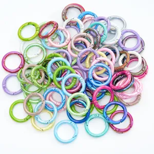 Colorful metal spring rings, open round snap hooks for DIY jewelry and keychains details.