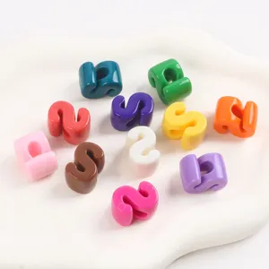 Close-up of vibrant colorful acrylic S shaped letter beads for DIY jewelry making crafts