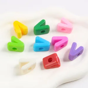 Macro view of colorful V-shaped acrylic beads with large holes for DIY jewelry making