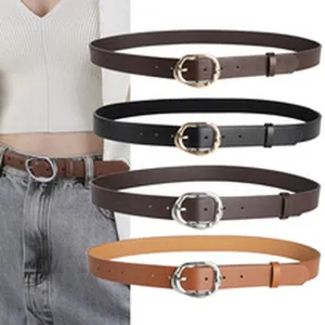 Detail view of versatile women's leather belts in black, brown, and tan with silver buckles.