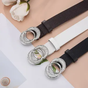 Close-up of stylish women's belts with sparkling rhinestone-encrusted buckles