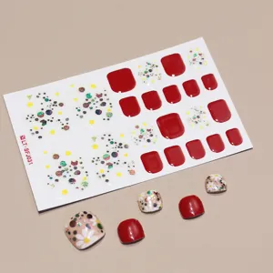 Detailed view of floral and red glitter toe nail stickers with 22 individual pieces.