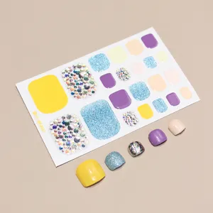 Detailed view of colorful toe nail stickers featuring glitter and rhinestone designs