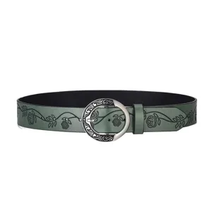 Detail showing vintage floral embossing on green leather belt with carved buckle