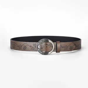 Vintage women's wide brown leather belt featuring intricate floral embossing and silver buckle detail