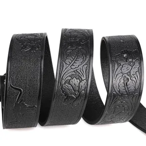 Black leather belt with floral embossing and bull skull motif, vintage punk style accessory.