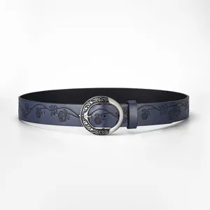 Detail showing floral embossing and vintage silver buckle on a dark blue leather belt