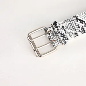 Close-up detail of women's retro snakeskin print belt with silver double buckle.