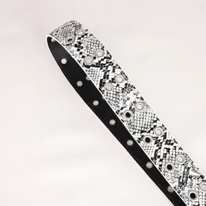 Women snake print belt detail featuring metal eyelets and retro black white design.
