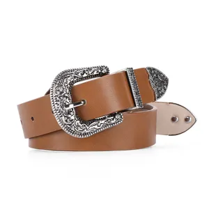 Detailed macro view of a women's vintage western belt featuring ornate silver carved hardware