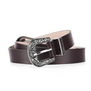 Detailed macro shot of a dark brown leather belt with vintage silver engraved buckle.