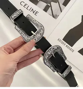Detailed view of black vintage belt with ornate silver Western-style buckles