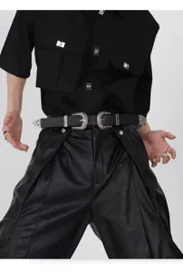Close-up detail of vintage black leather belt featuring double silver carved buckles style