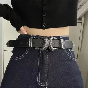 Close-up of women's vintage black leather belt featuring ornate double silver buckles