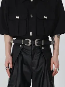 Detail of vintage black leather belt with double ornate silver engraved buckles