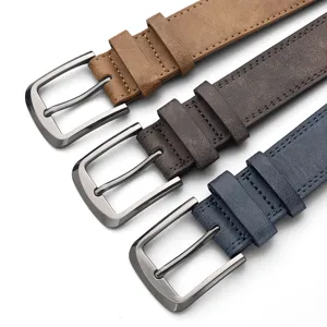 Close-up of three vintage men's PU belts with metal pin buckles in various colors and textures