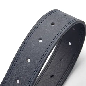 Macro shot of a vintage PU leather belt showing fine stitching and precision holes.