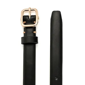 Macro detail of slim black leather belt featuring a minimalist gold square pin buckle