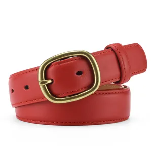 Close up detail of red leather belt with vintage alloy buckle and clean stitching.