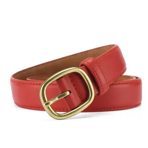 Close-up detail of red leather women belt featuring a vintage brass pin buckle and neat stitching.