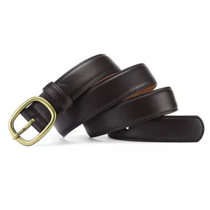 Close-up detail of women's dark brown leather belt with vintage brass buckle and stitching.