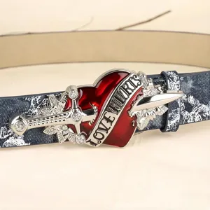 Detailed close-up of the vintage punk red heart dagger metal belt buckle and washed strap.
