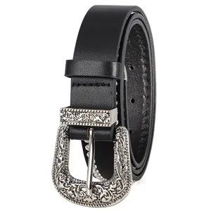 Detail view of black punk style leather belt with silver engraved buckle and studs.