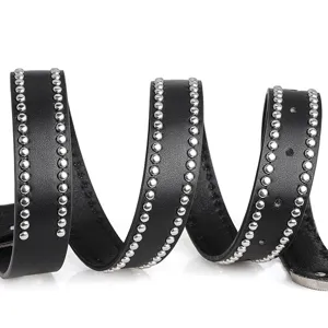 Close-up detail of a punk-style black leather belt with silver round rivets along the edges.