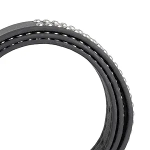 Macro view of a black punk leather belt with silver metallic stud details