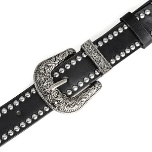Close-up of black leather punk belt with silver rivets and vintage buckle