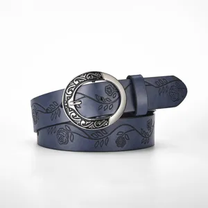 Detailed view of a navy blue vintage leather belt with floral embossing and round buckle