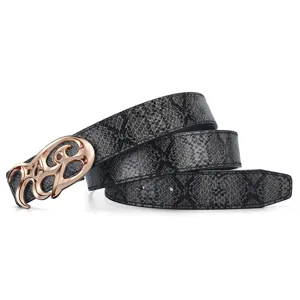 Detailed view of grey snakeskin patterned vintage belt with a stylized golden metal buckle
