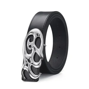 Detailed view of a vintage black leather belt featuring a large silver abstract scrollwork buckle