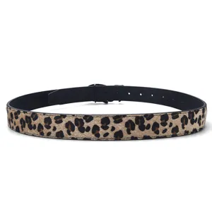 Close-up of reversible leopard print belt with vintage aesthetic and black lining.