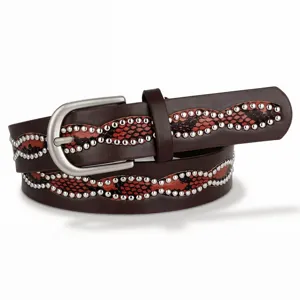 Close-up detail of brown leather belt with red snakeskin pattern and silver studs