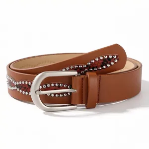 Detail view of a brown leather belt featuring silver studs and a stylish red pattern inlay.