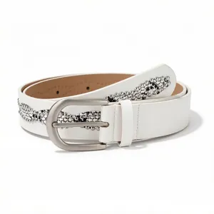 Close-up of white women's belt featuring silver rhinestone wave patterns and matte buckle