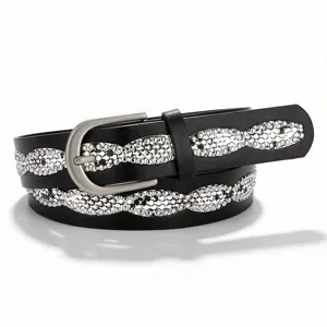 Close-up of black fashion belt featuring shiny rhinestone wave pattern for women