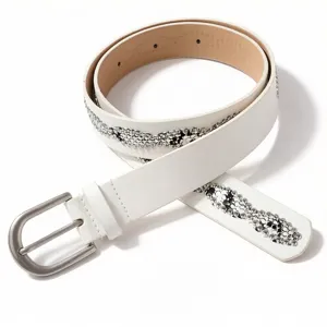 Close-up detail of a white fashion belt featuring sparkling rhinestone snake pattern