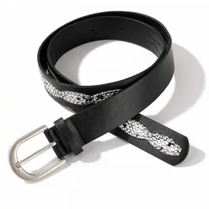 Close-up of black leather belt featuring sparkling silver rhinestone pattern inlay