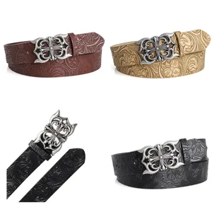 Detail view of gothic cross buckle leather belt with embossed floral pattern variations.