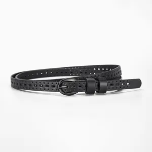 Close-up of black thin leather belt with minimalist needle buckle and hollow pattern
