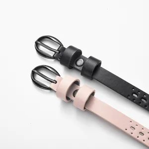 Close-up detail of black and pink hollow-out women belts with metallic pin buckles