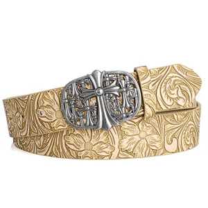 Close-up view of vintage leather belt with metallic cross buckle and floral embossed details.