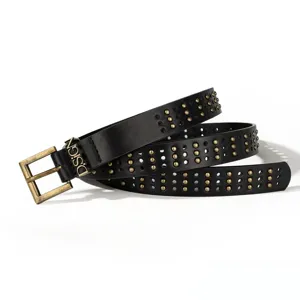 Detail shot of black punk belt with gold rivets and a D.SIGN metal buckle for women