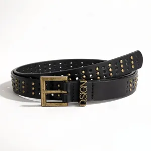 Detailed shot of black punk rivet belt with gold studs and engraved D.SIGN buckle