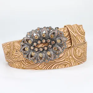 Macro view of vintage embossed leather belt with ornate rhinestone floral buckle